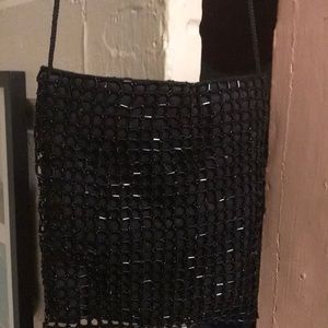 Lovely n like new.  Black beaded bag with square design has satin cord n snaps